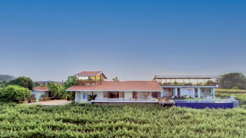 Nashik Villa | SaffronStays Onellaa, Nashik - infinity pool villa surrounded by a vineyard