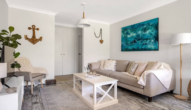 Chic designer garden apartment moments from beach!