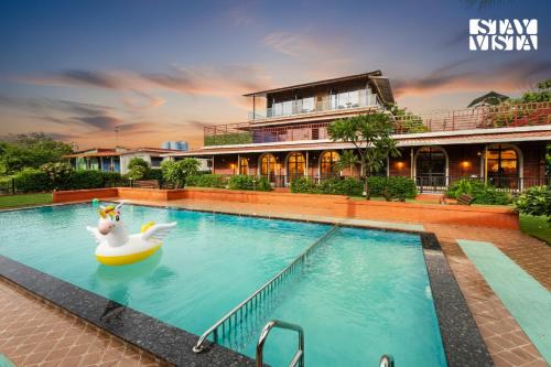 StayVista at Greenwich Meridian with Pool, River & Mountain View in Chinchavli