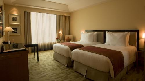 The Grand Deluxe Room with Twin Bed with 20% off on session of 30 mins Spa,15% off on food & soft beverage services,20% Discount on Laundry service (T&C applicable)