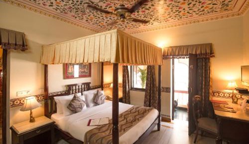 Royal Deluxe Room: Free pickup on arrival from train or bus station. Enjoy a daily Rajasthani dance & music show from 7–9 PM, swimming pool, and a dedicated travel desk to assist with local sightseeing tours, intercity travel arrangements & activities